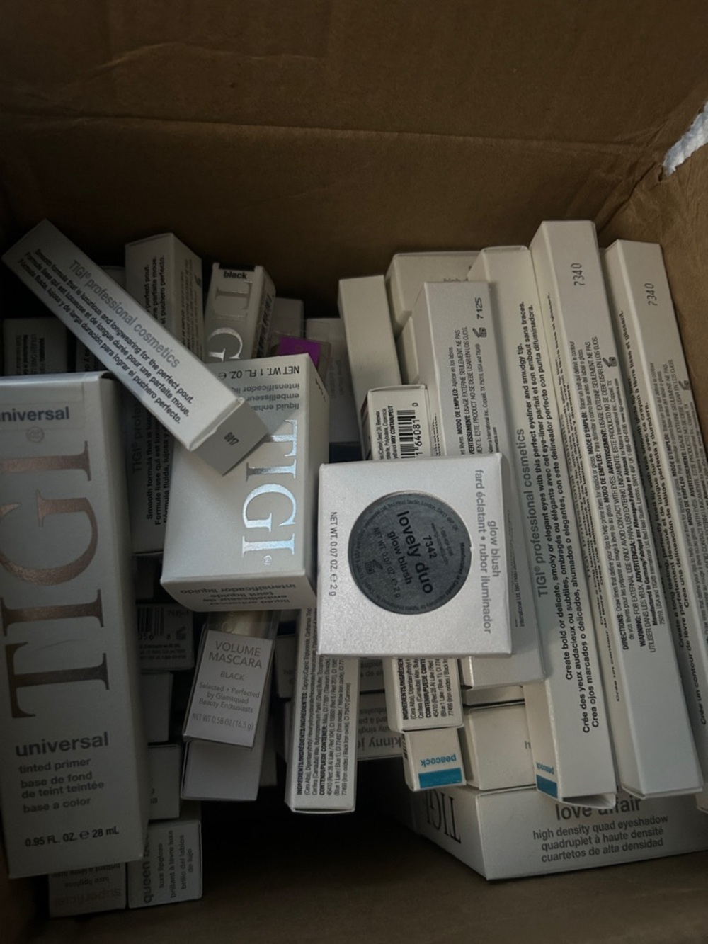 TIGI Cosmetics Assorted Boxed Makeup in White and Silver Packaging